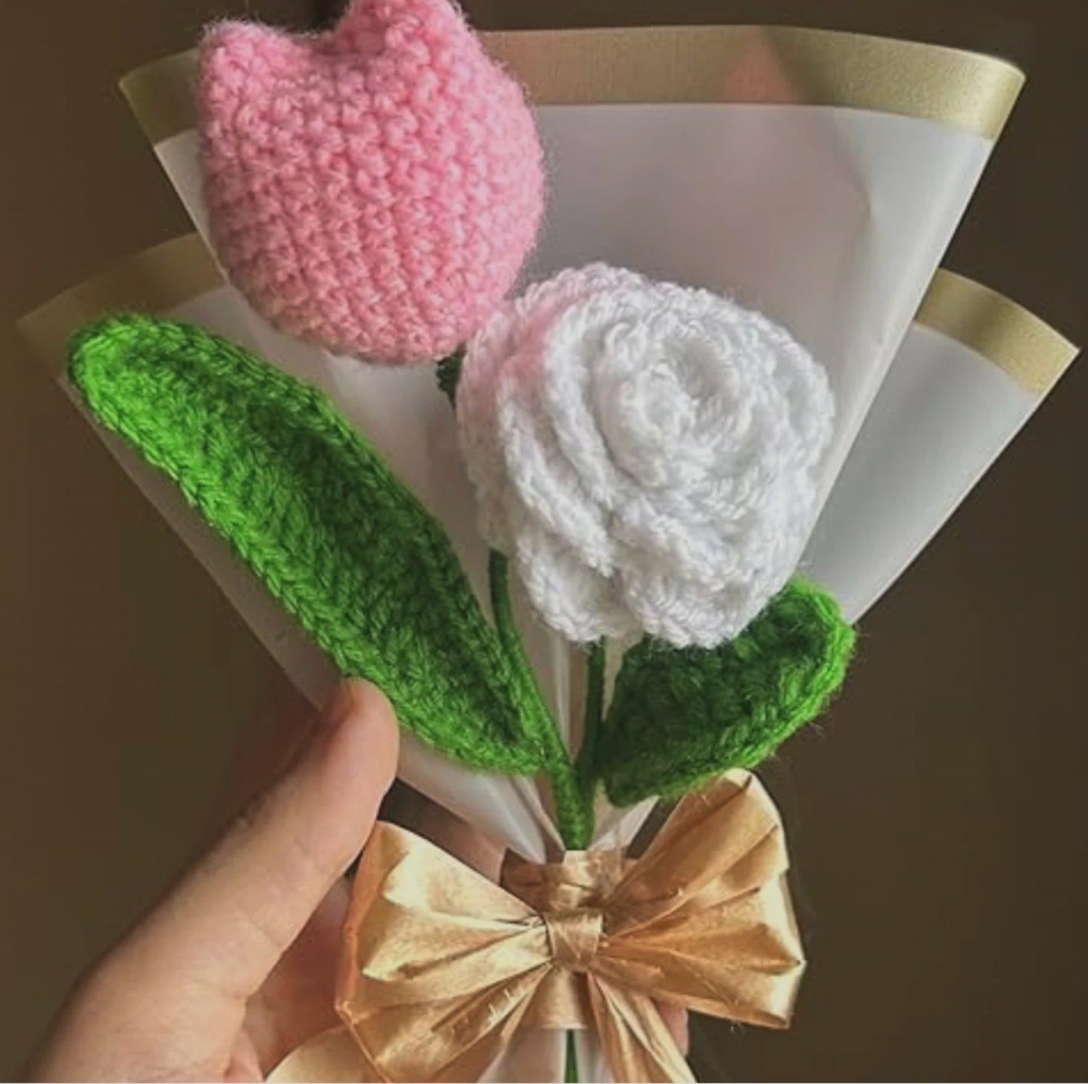 Pink crochet tulip and white rose bouquet tied with shimmering gold bow