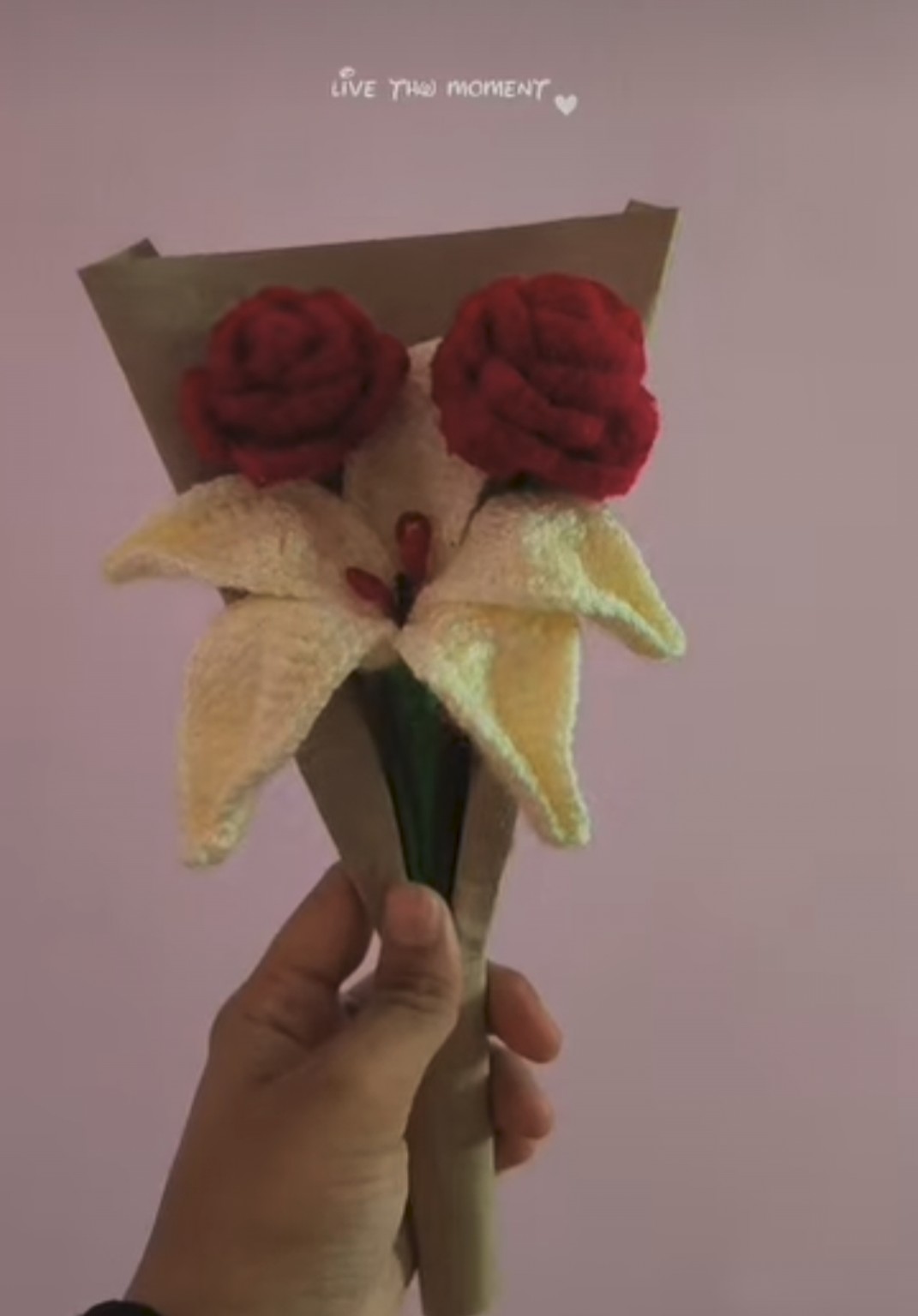 Handmade dual red roses paired with a blooming lily in paper cone