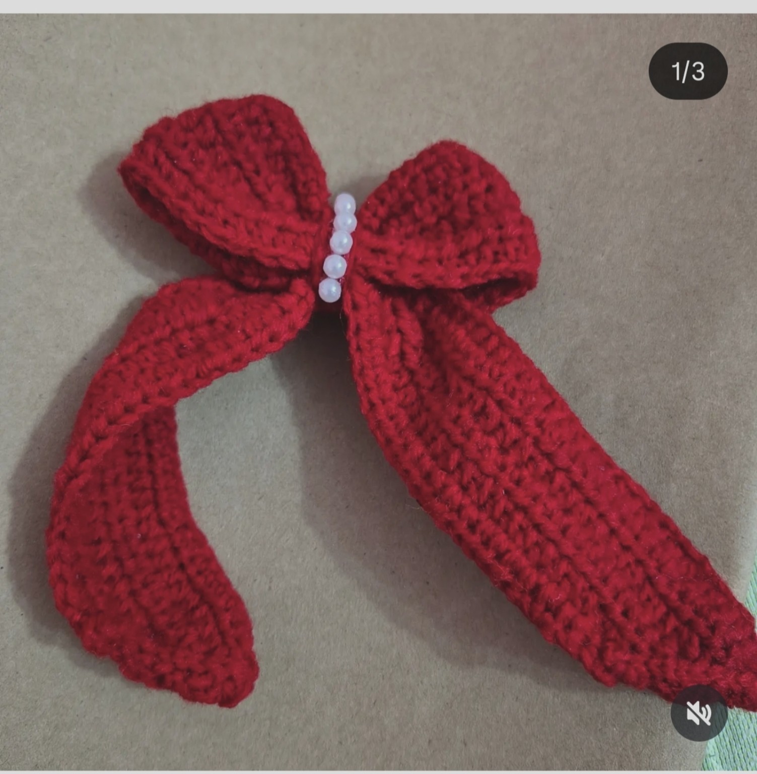 Hand-knitted elegant crochet bow featuring delicate faux-pearl bead centerpiece
