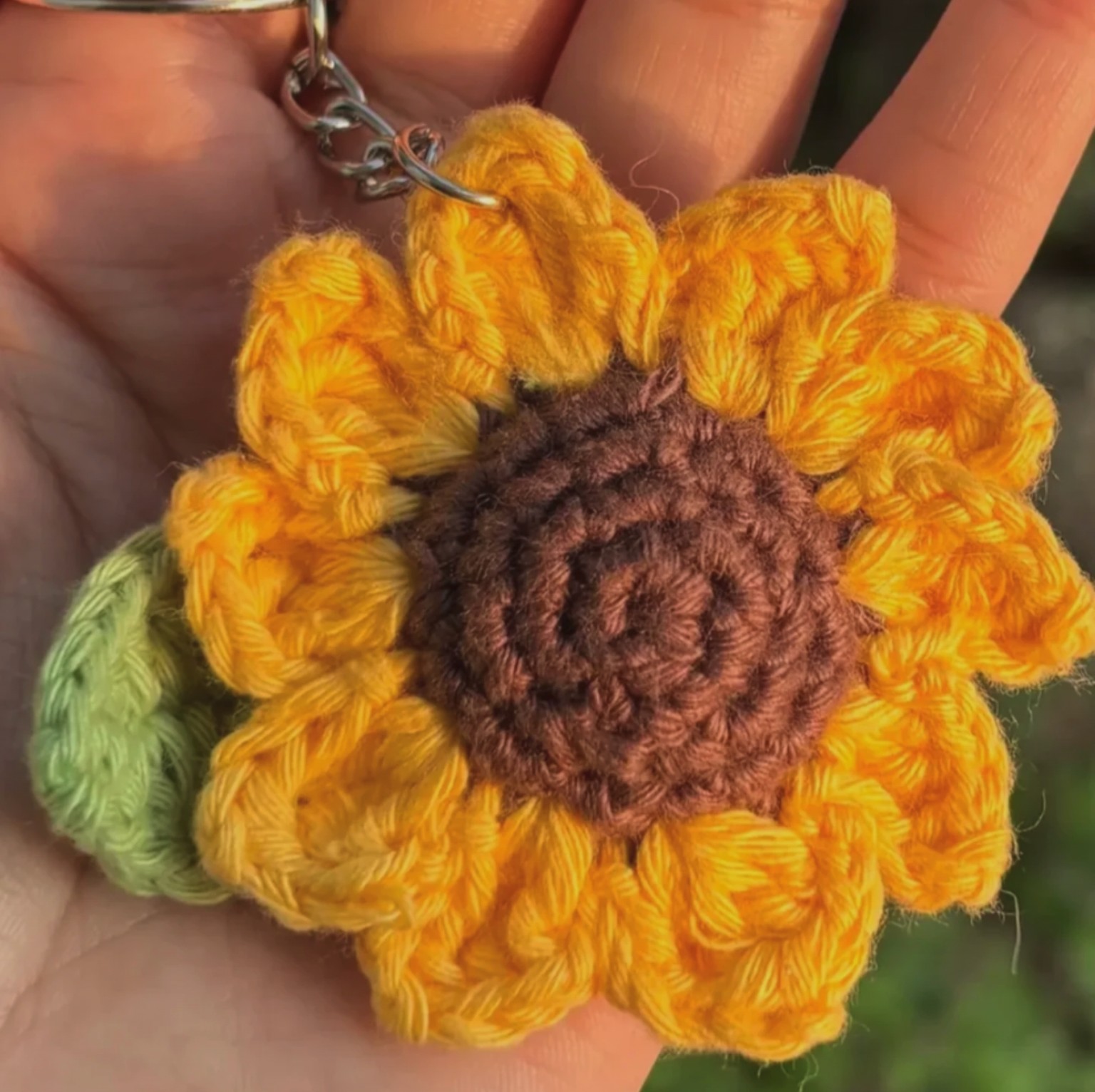 Vibrant golden sunflower hand-crocheted with rich chocolate center